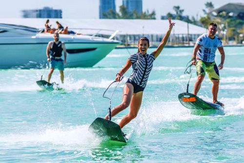 Une femme et deux hommes en train de faire du jet surf